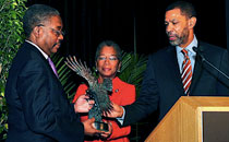 Photo of Dr. David Rivers receives award from the Honorable Donna Christensen and Mr. Michael Rashid for serving as Conference Chair.